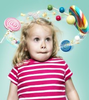 Little girl with flying candies around her head, Composite